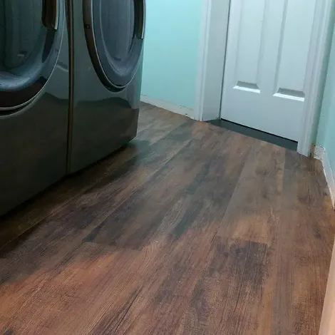 Laundry room with vinyl wood flooring